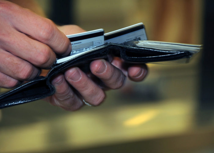 US_Navy_080918-N-0659H-001_A_Naval_Support_Activity_Mid-South_Sailor_takes_a_moment_to_decide_which_credit_card_to_use